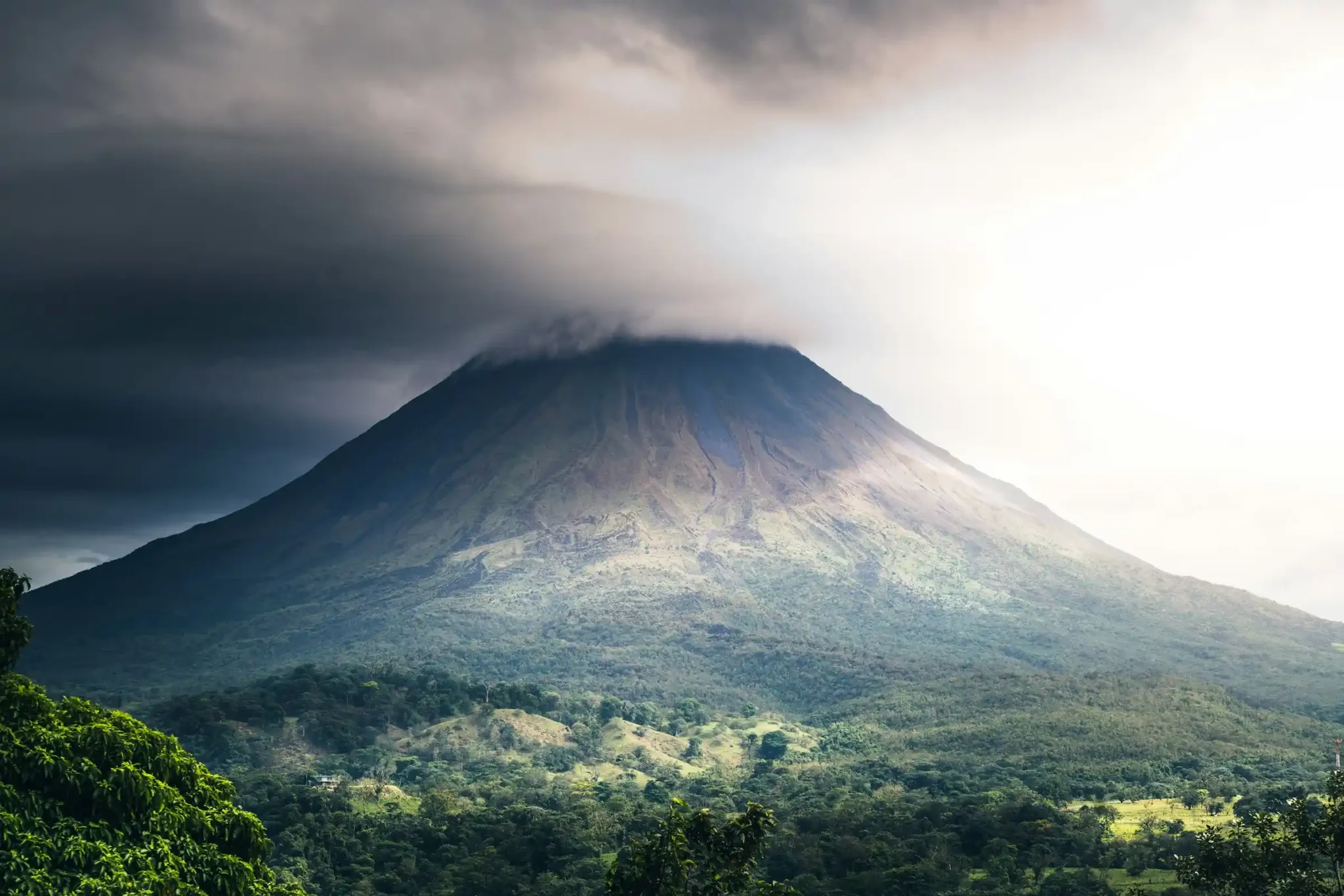 Arenal Volcano wrapped in cloud during the green season in Costa Rica