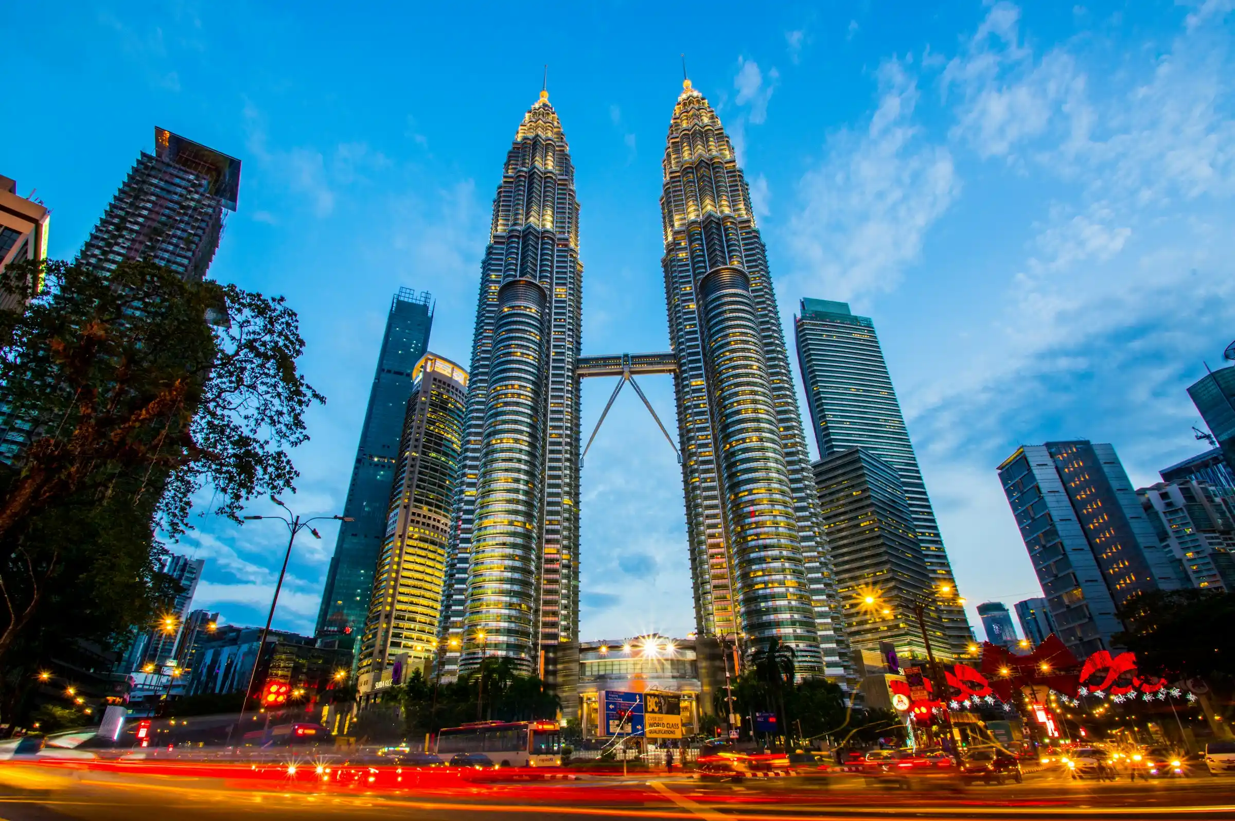 The illuminated Petronas Twin Towers in Kuala Lumpur at dusk, Malaysia
