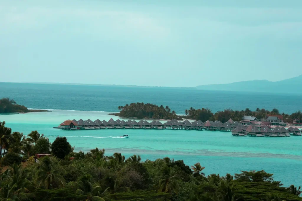 Overwater bungalows on the turquoise Bora Bora lagoon with Mount Otemanu behind