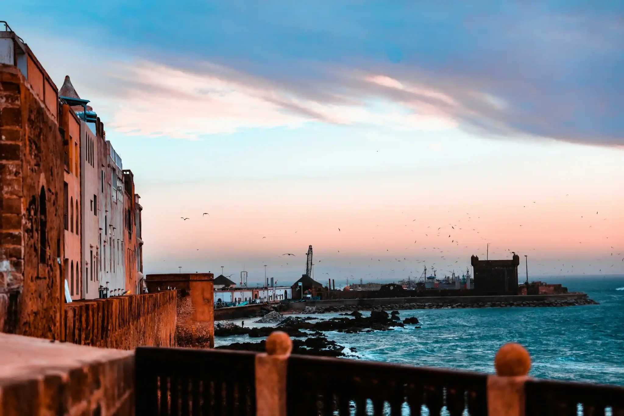 Essaouira harbour with blue fishing boats and the old medina walls