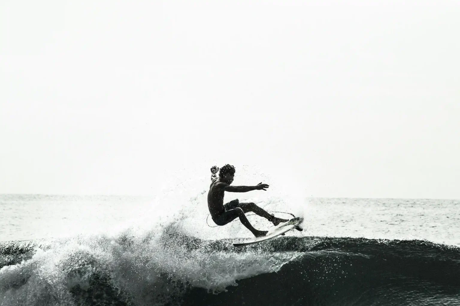 A surfer riding a wave off Fernando de Noronha, Brazil