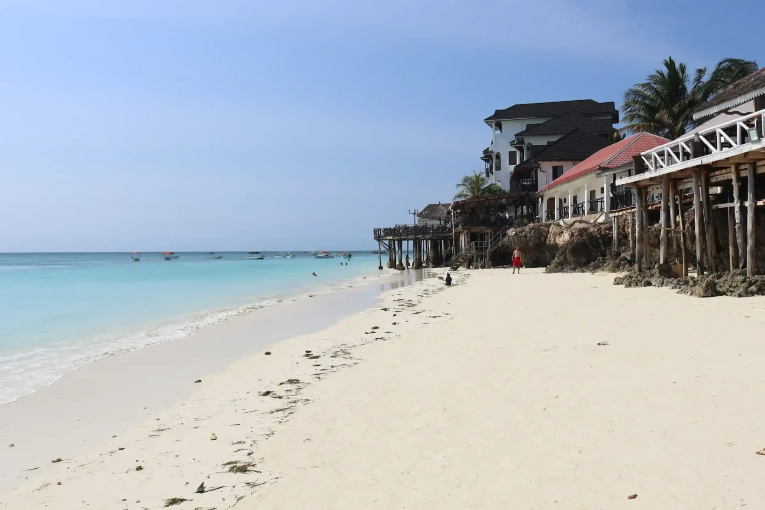 Nungwi Beach in Zanzibar with turquoise water and traditional dhow boats