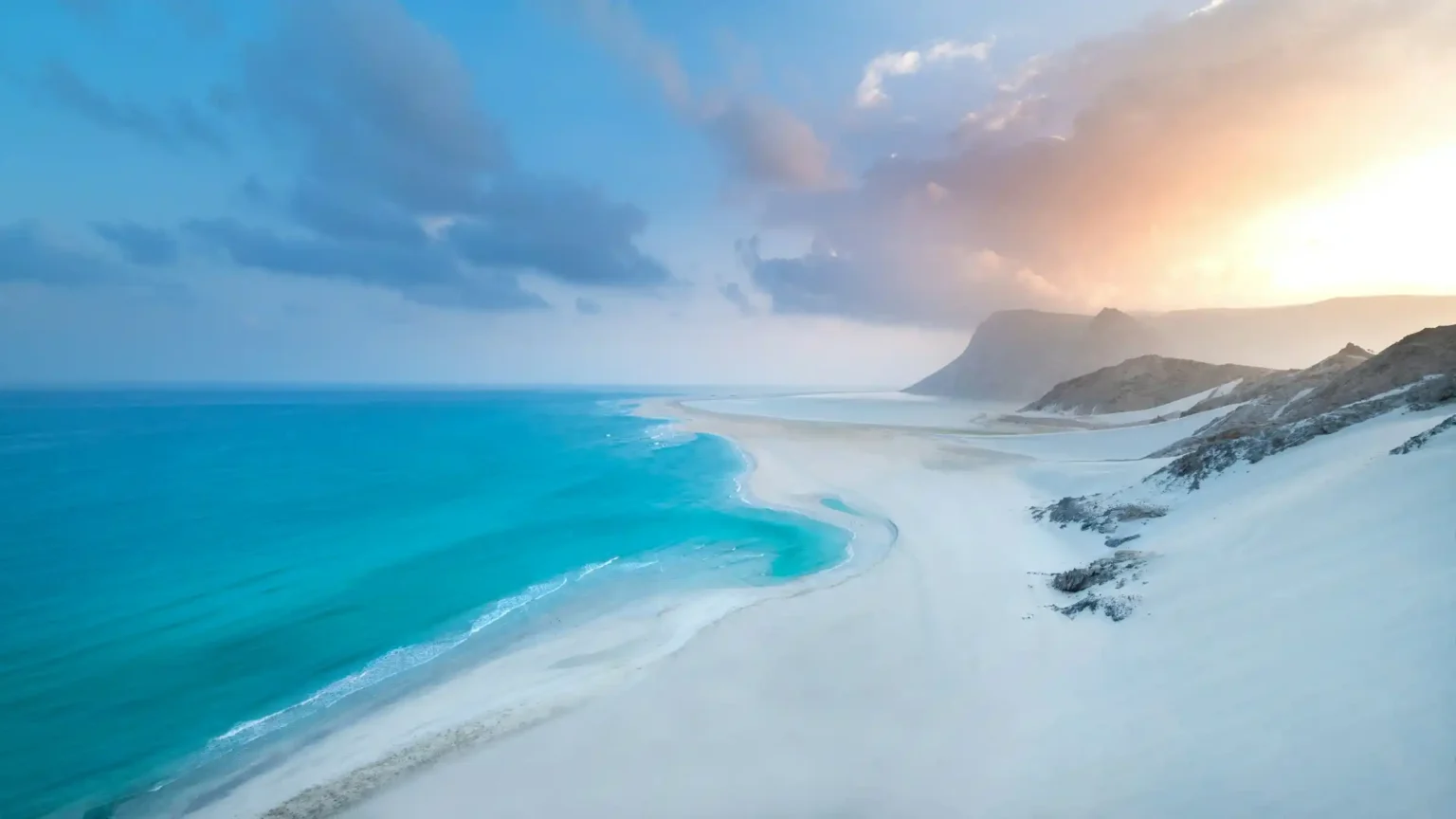 White sand dunes meeting the turquoise sea on the coast of Socotra Island
