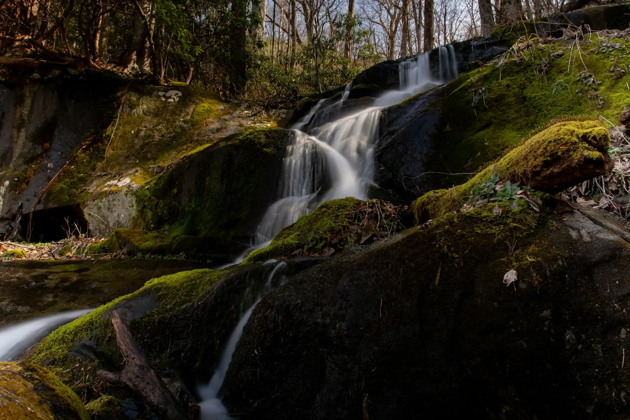 Small waterfall cascading over moss-covered rocks along a Smoky Mountains hiking trail near Gatlinburg