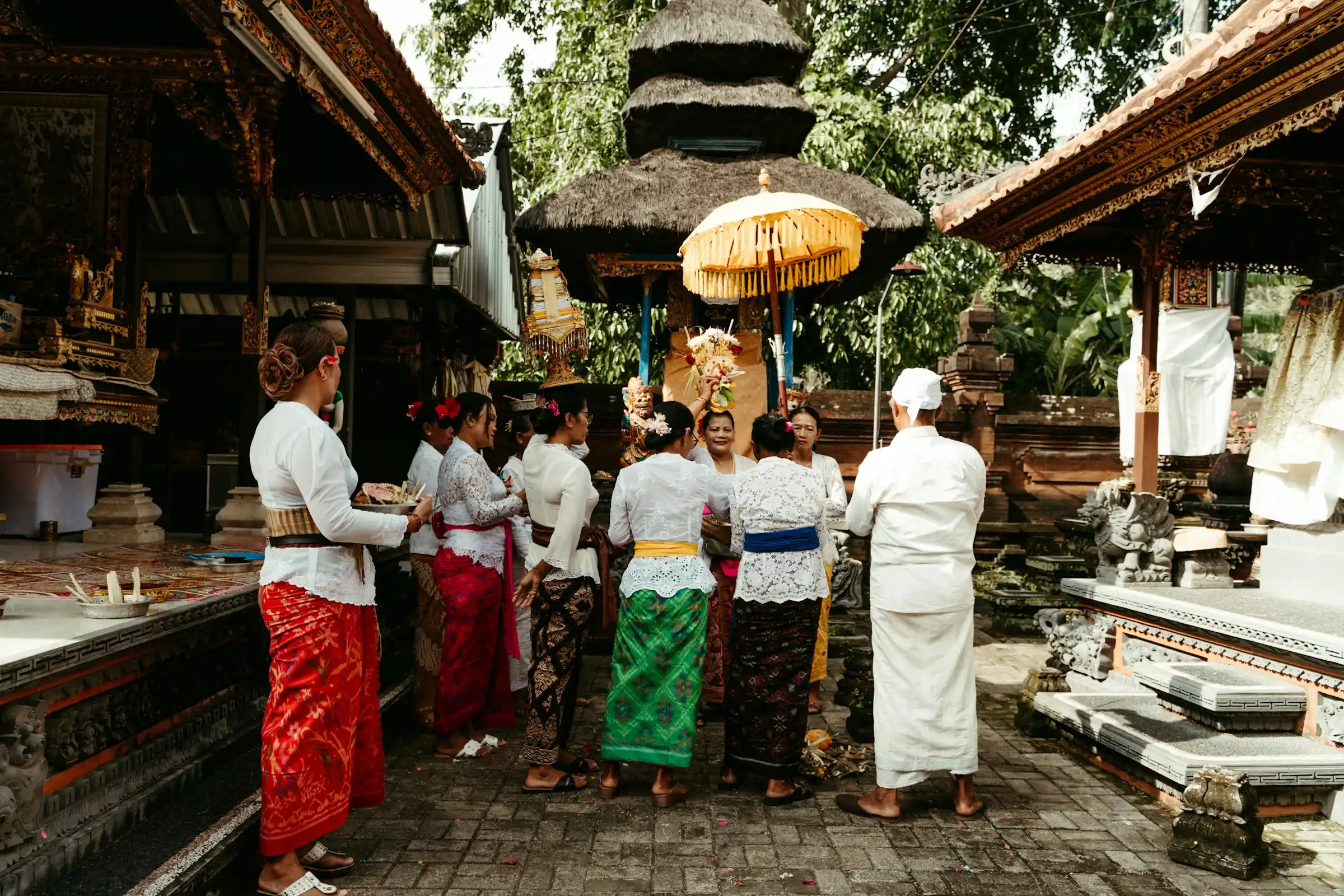 Visitors in sarongs at a Balinese temple gate
