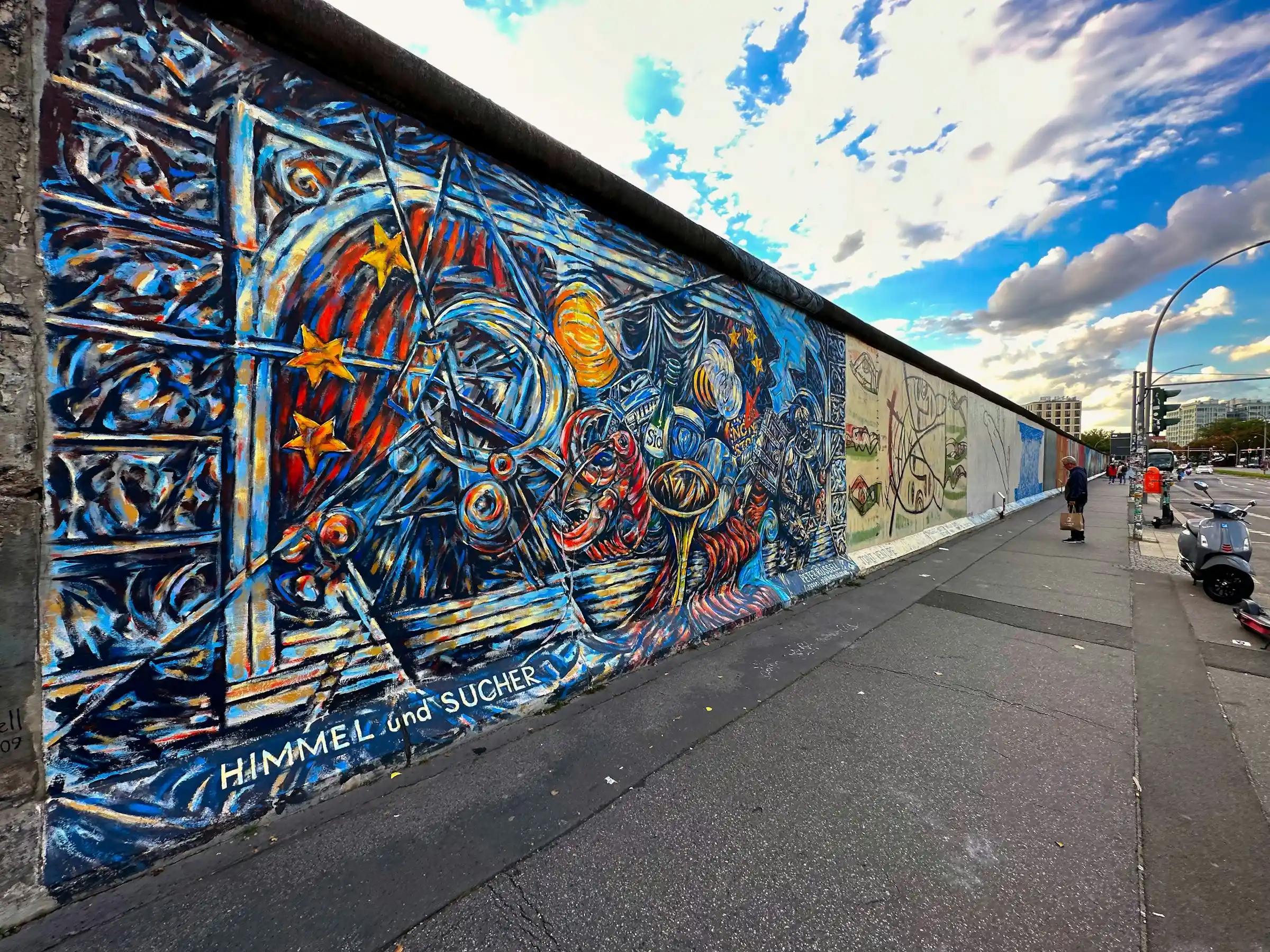Street art and stencils covering a doorway and wall in a Berlin side street