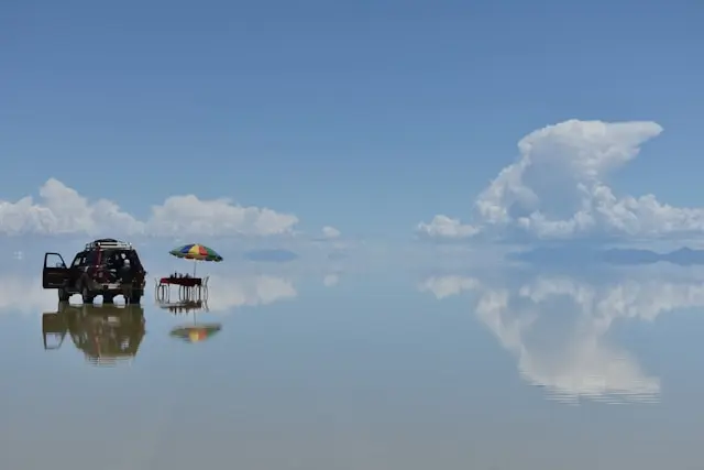 Salar de Uyuni during the wet season showing a perfect mirror reflection of the sky across the flooded salt flat