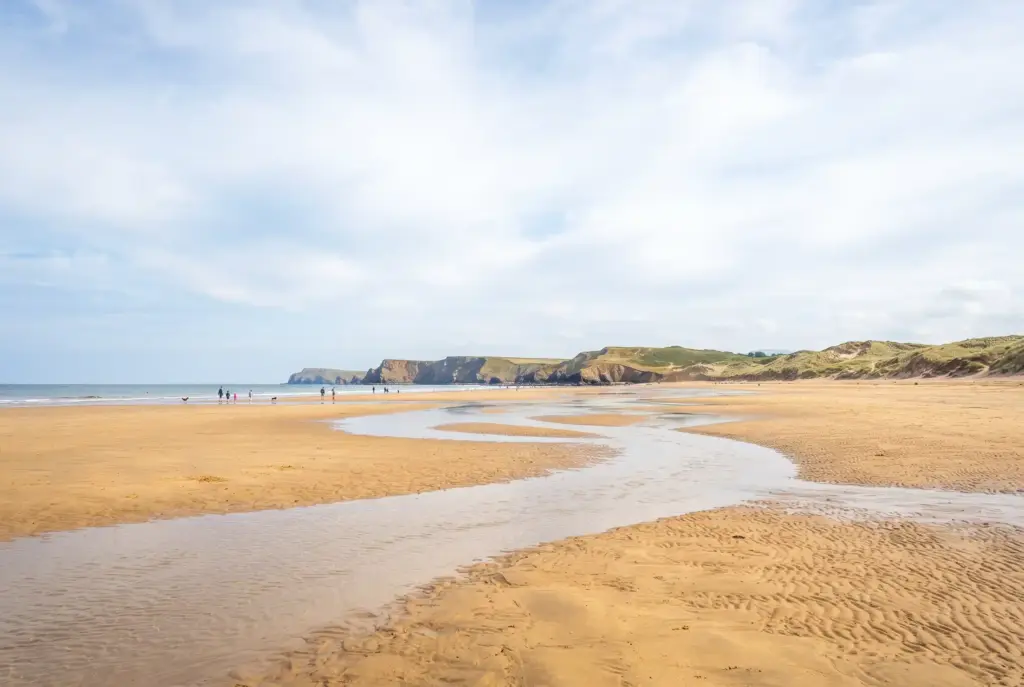 Wide golden sands at low tide on Perranporth beach