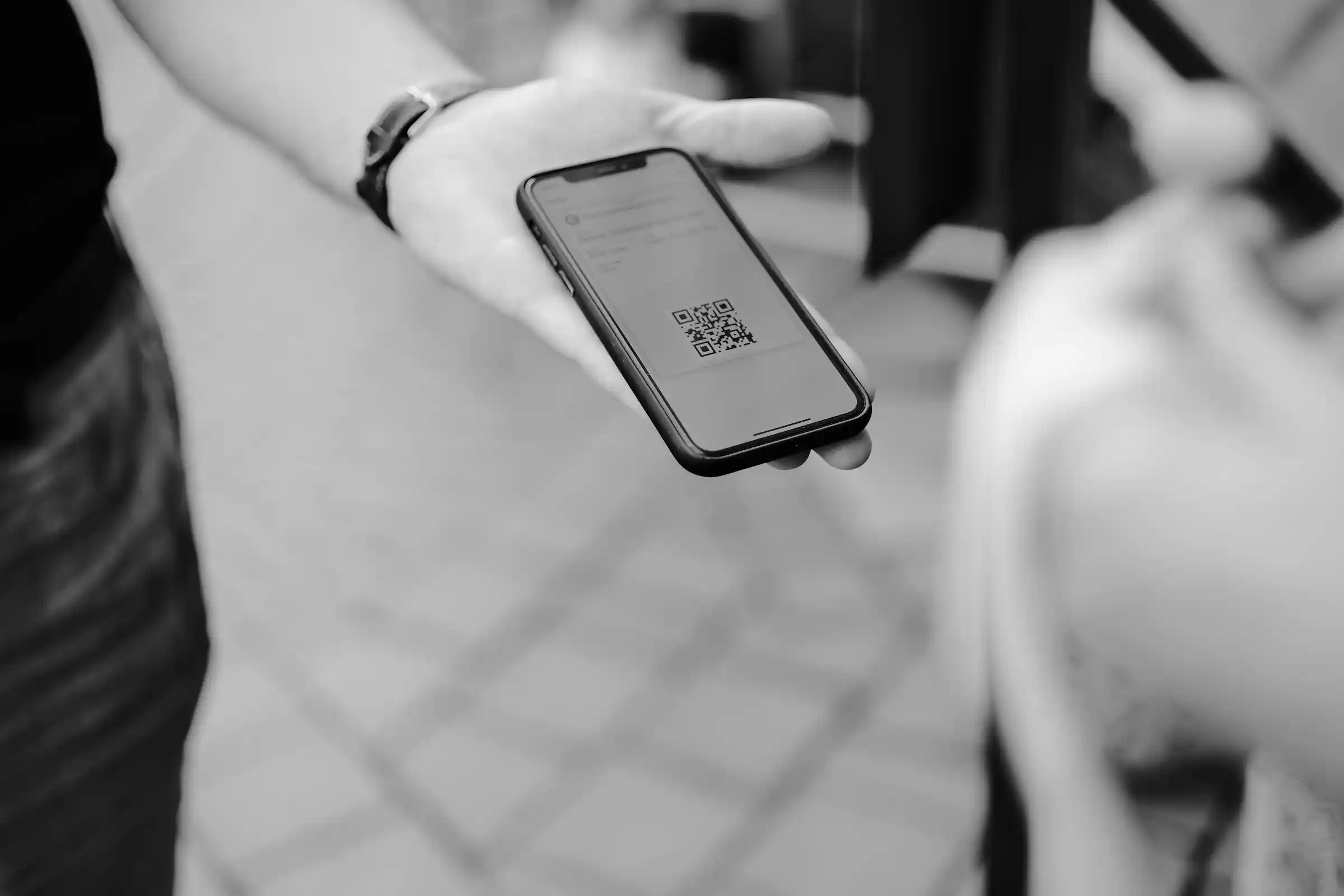 Traveller showing an eTravel QR code on a phone at a Philippine airport arrivals hall