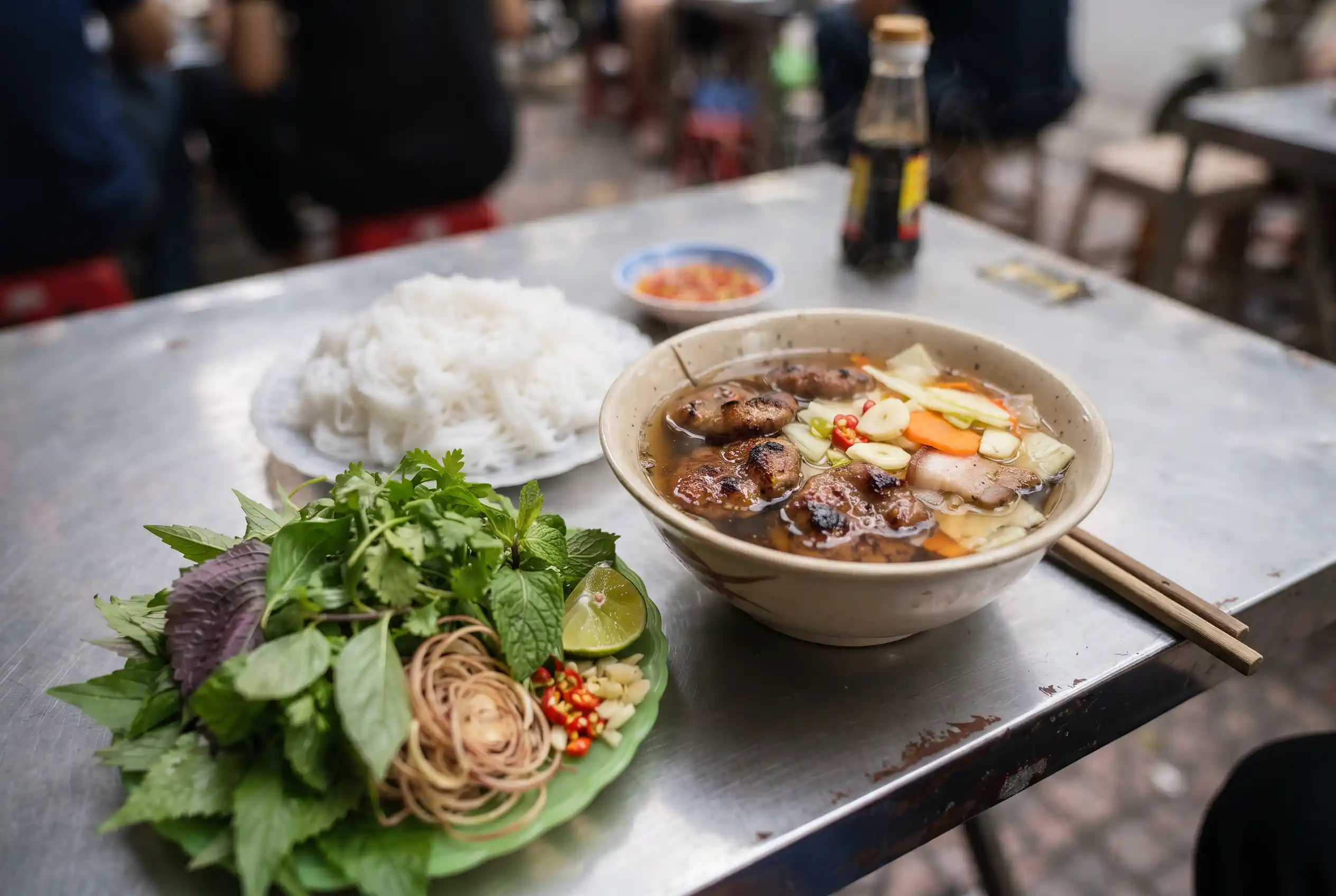 A plate of Hanoi bun cha with grilled pork, vermicelli, and herbs