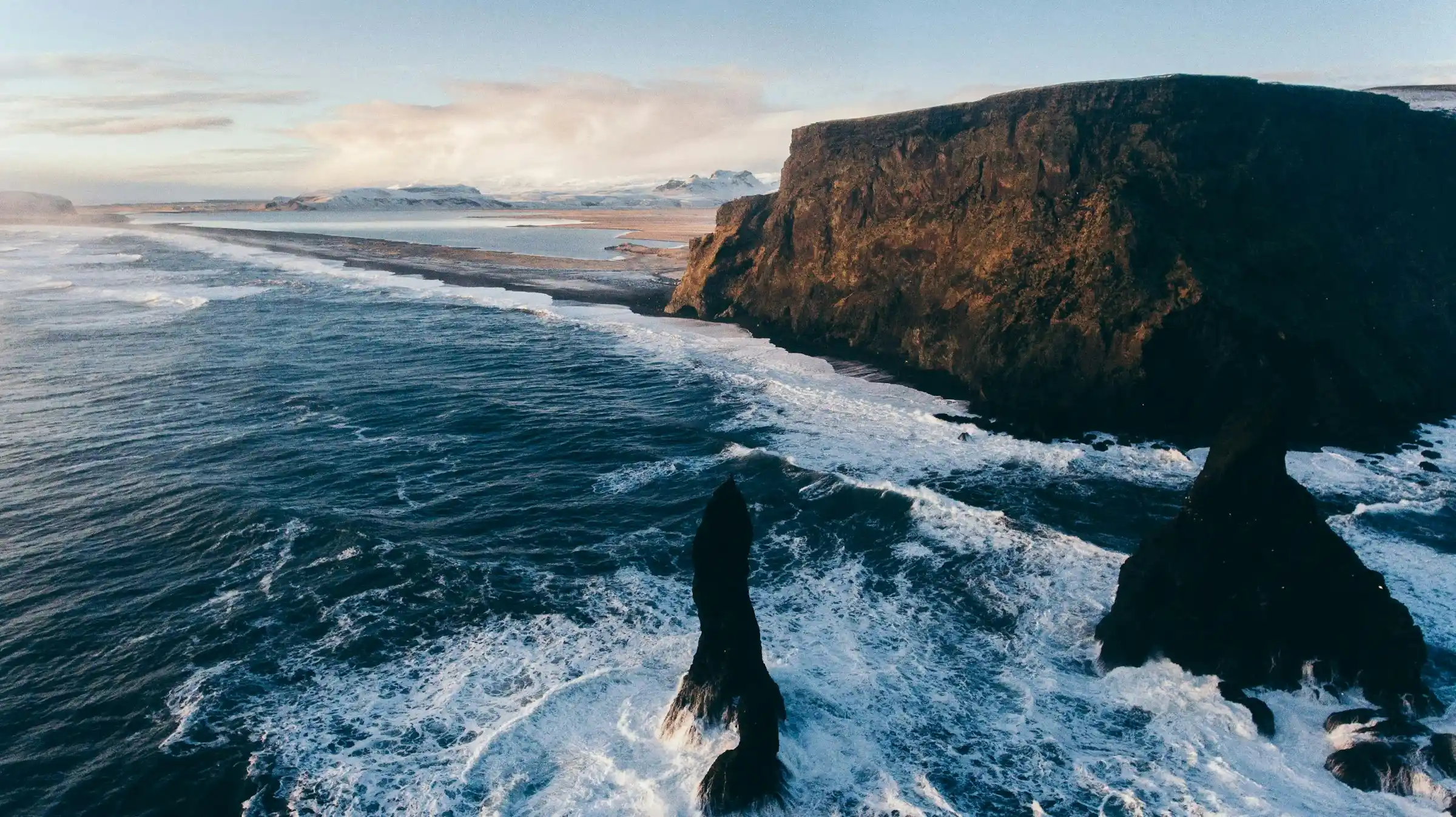 Chunks of clear glacier ice scattered across the black sand of Diamond Beach in Iceland