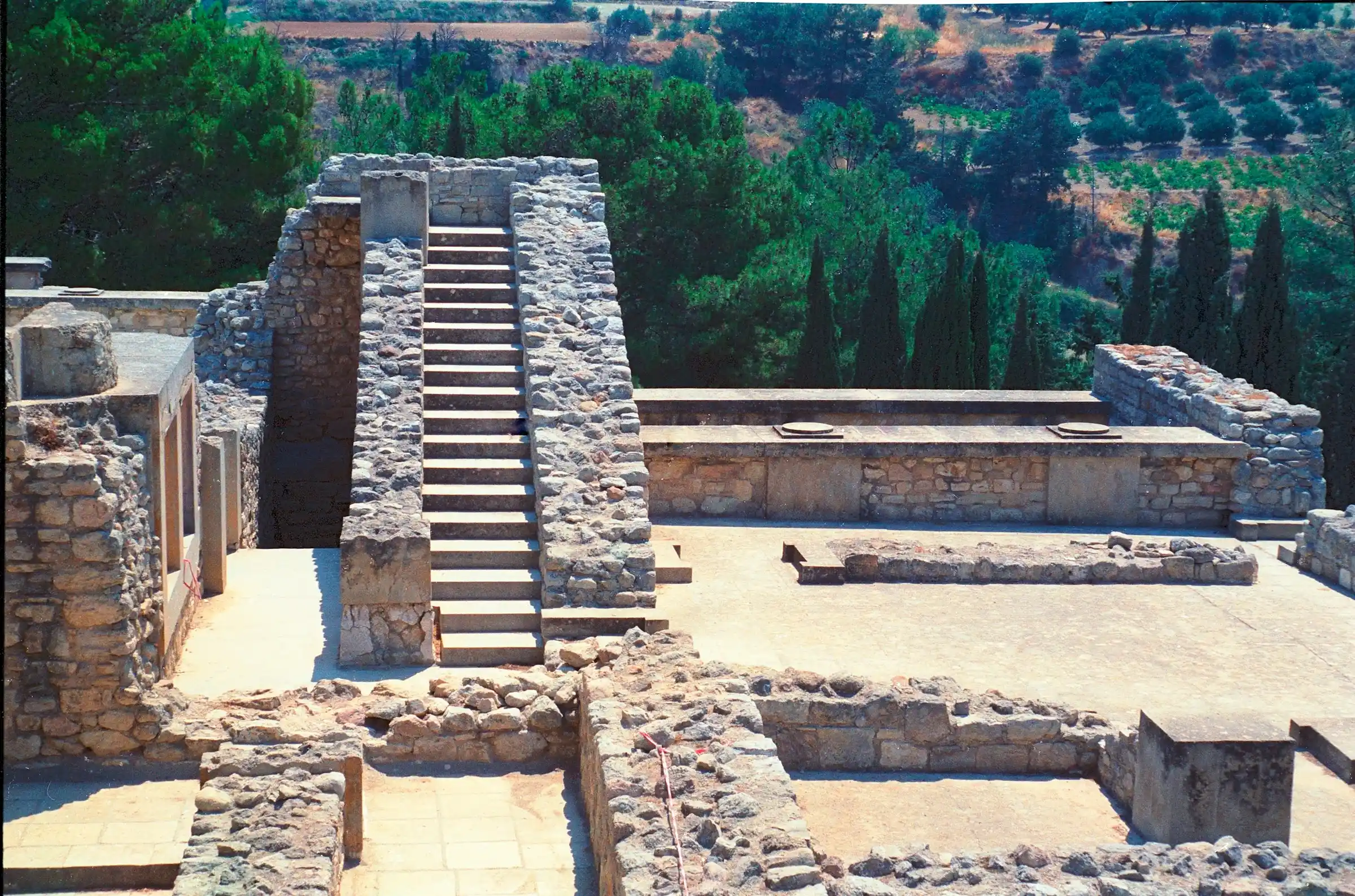 The sprawling stone ruins of the Palace of Knossos seen from above