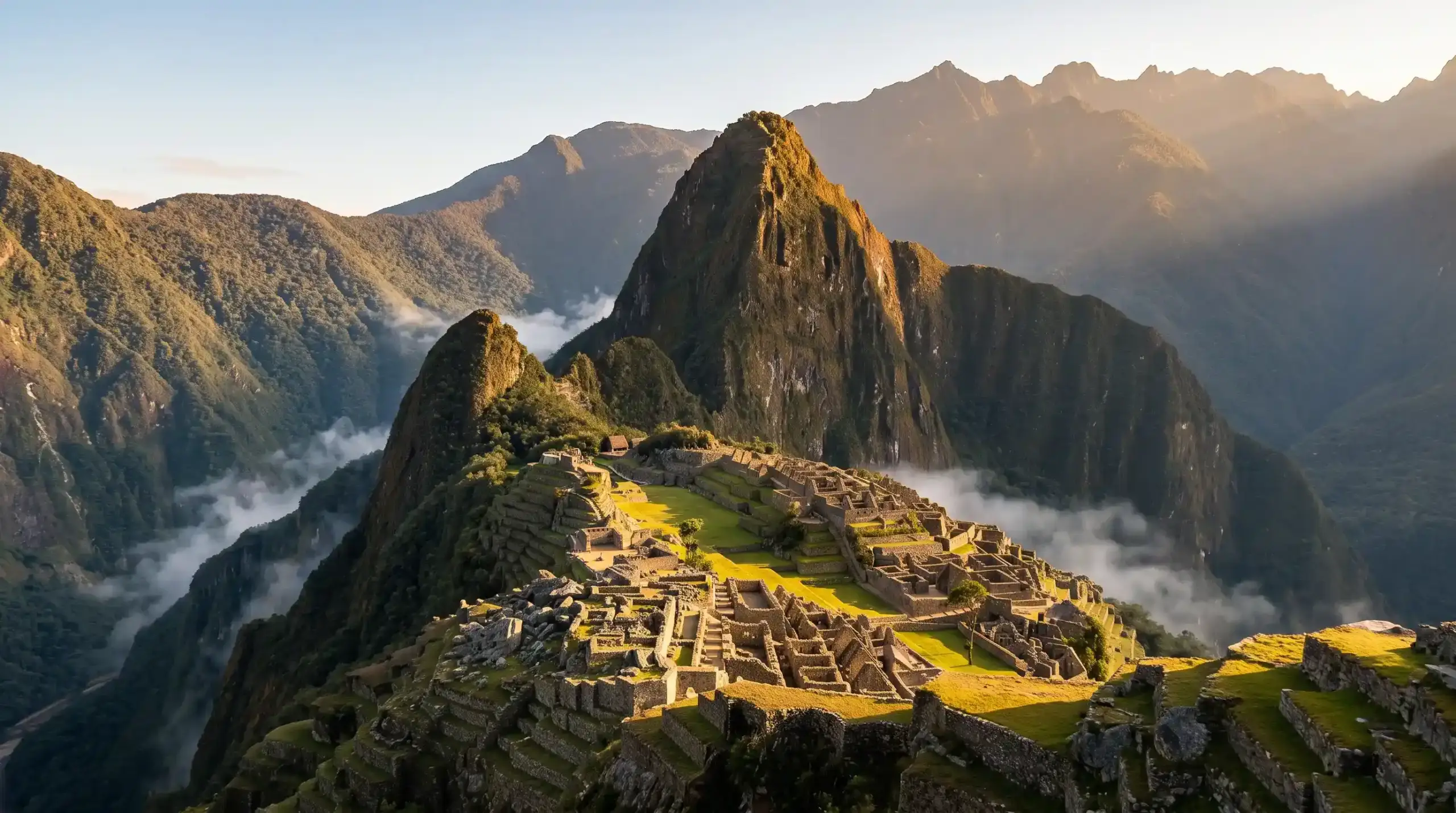 Golden sunrise illuminating Machu Picchu with Huayna Picchu in background