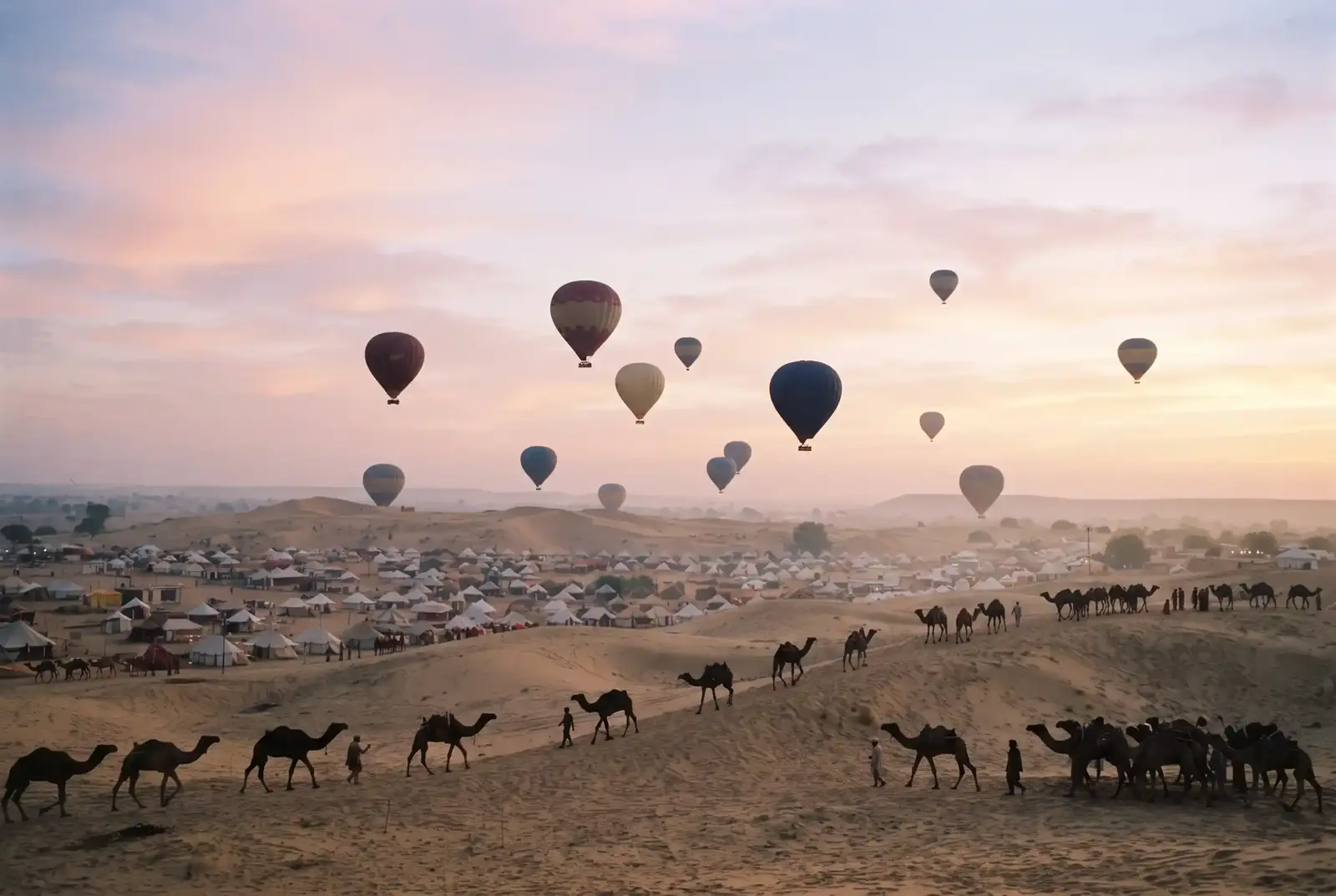 Hot-air balloons rising over the Pushkar fair at dawn