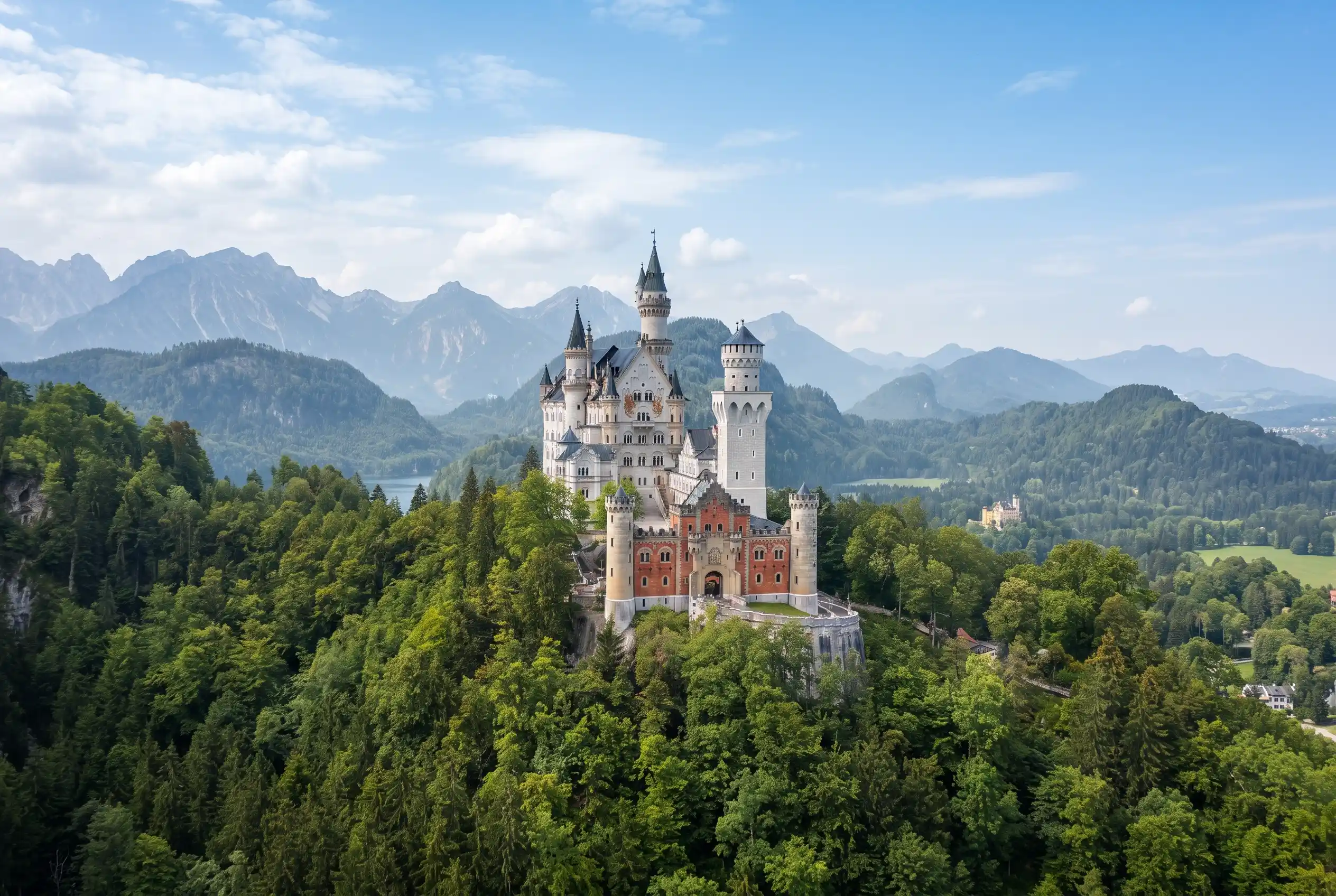 Neuschwanstein Castle on a wooded hill at the southern end of the Romantic Road