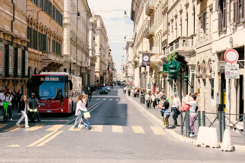 An ATAC bus passing ancient ruins in central Rome