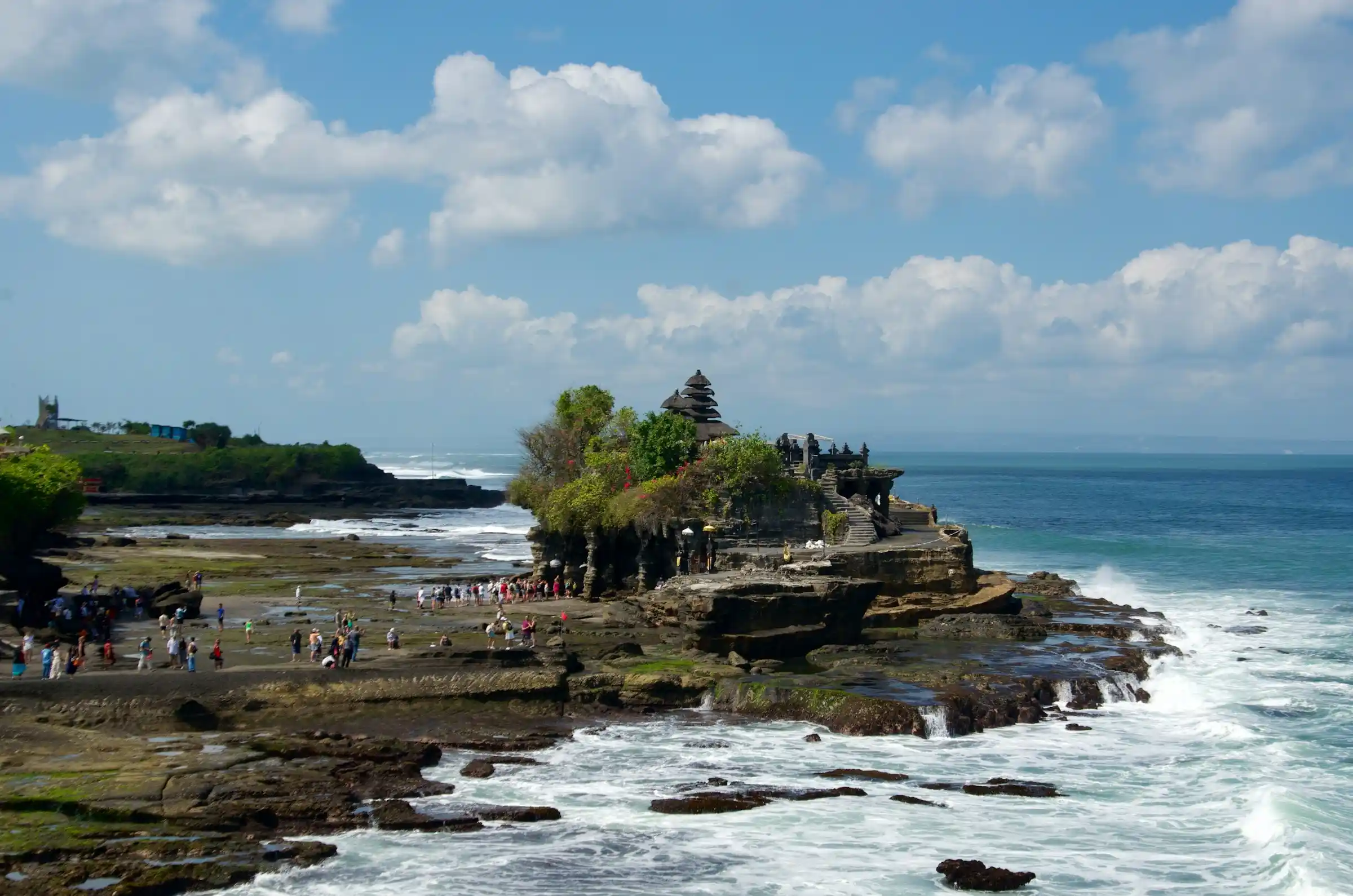 Visitors crossing to Tanah Lot at low tide, Bali