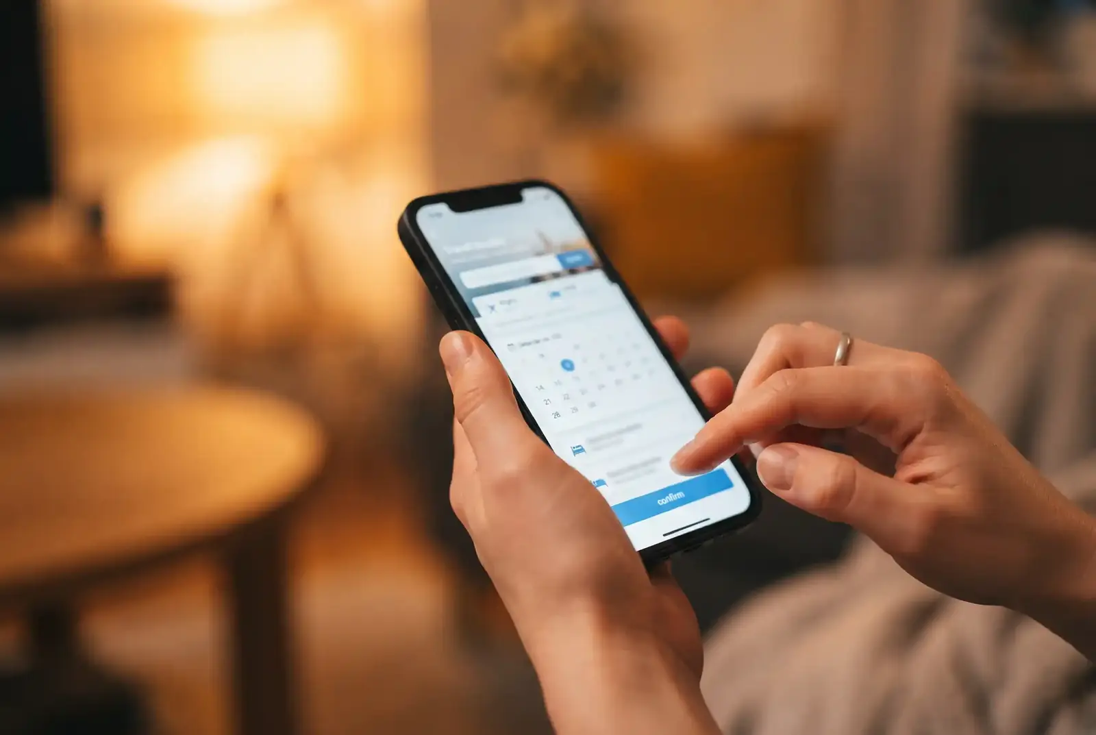 Hands booking train travel on a smartphone