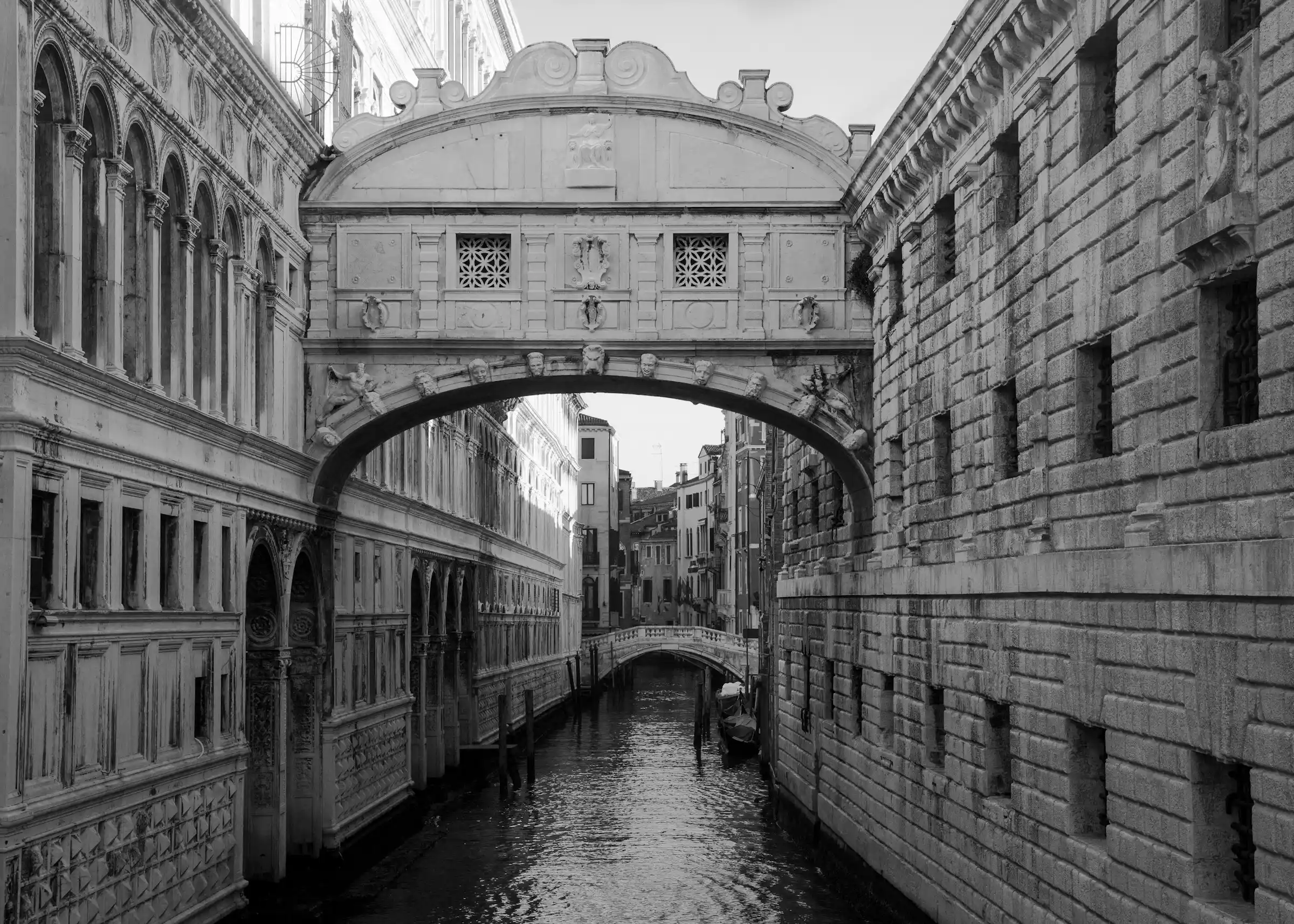 The enclosed white Bridge of Sighs between two buildings over a canal in Venice