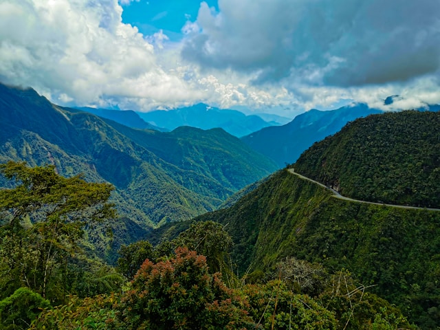 The North Yungas Road winding along a narrow cliff edge through dense cloud forest